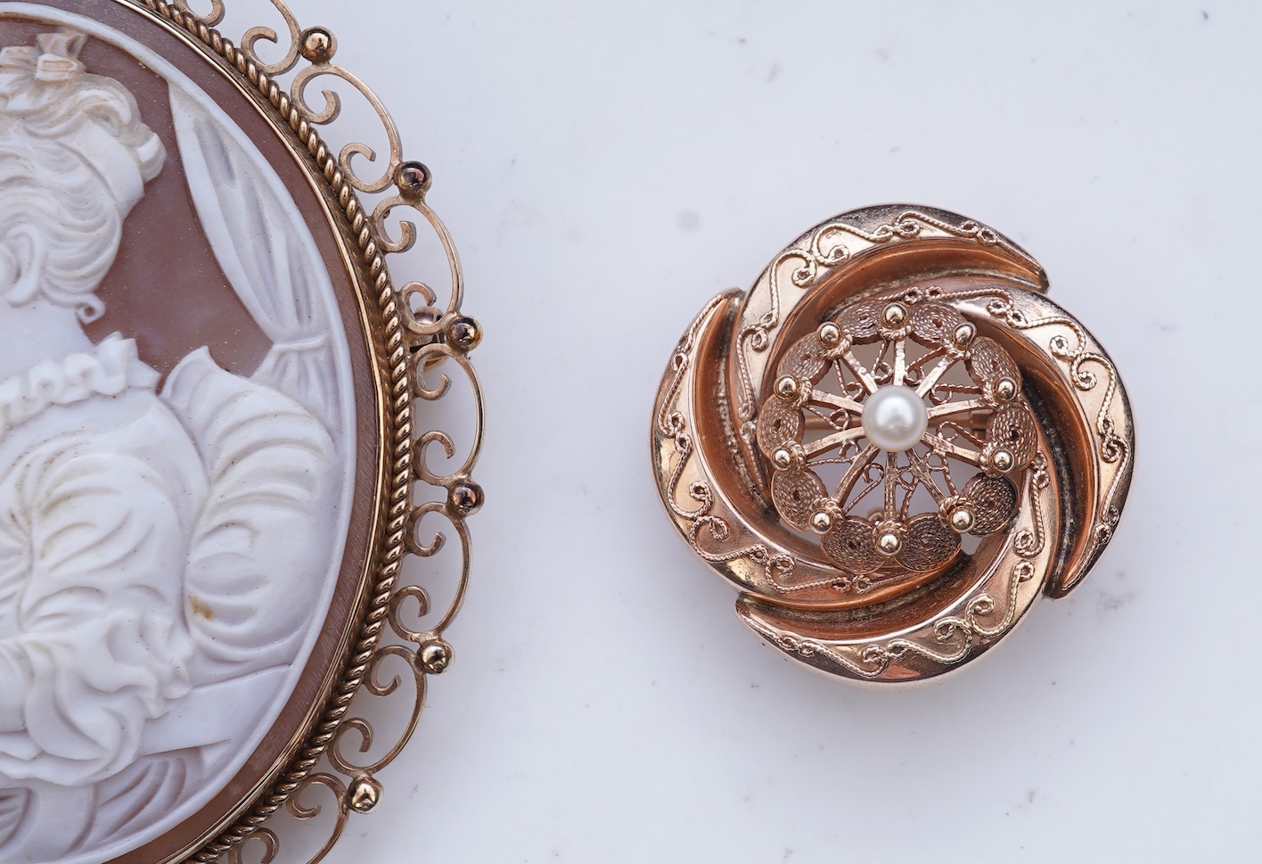 A shell cameo brooch and a gold and cultured pearl brooch
